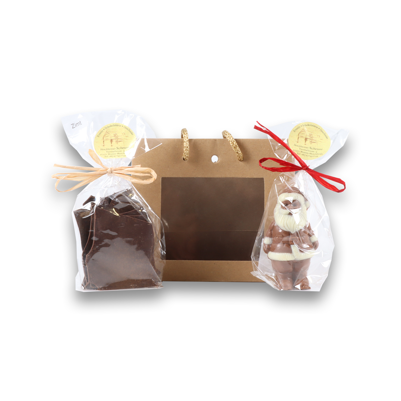Kleiner Weihnachtsmann und Zartbitterschokolade stehen vor der Tasche